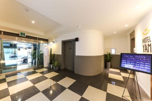 a lobby of a building with a checkered floor at Hotel Yam in Daejeon