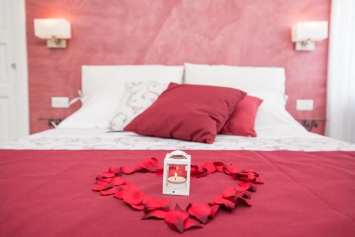 a bed with a heart made out of red roses at Valle d'Amalfi Suites in Amalfi