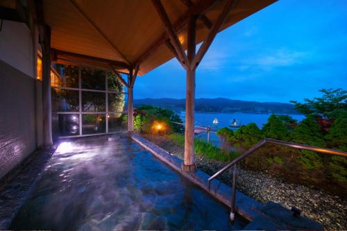 a house with a swimming pool at night at Kesennuma Plaza Hotel in Kesennuma