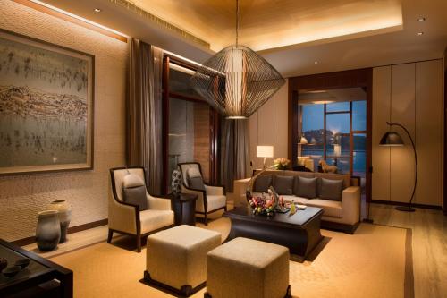 a living room with a couch and chairs and a table at Yanqi Hotel, Managed by Kempinski in Huairou