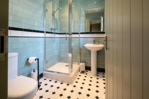 a bathroom with a shower and a sink and a toilet at The Cowdray Arms in Haywards Heath