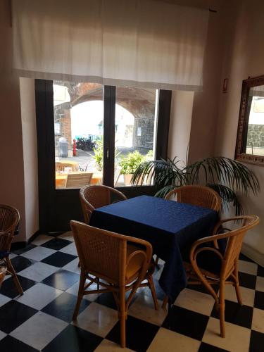 a dining room with a blue table and chairs at Albergo Lungomare in Bonassola