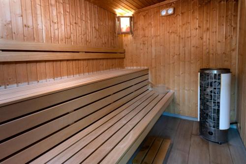 a sauna with a bench and a trash can at Ani Central Inn in Yerevan