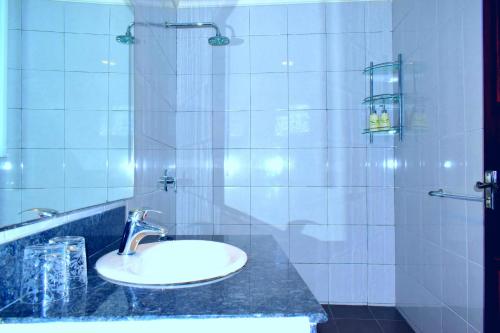 a bathroom with a sink and a shower at Asian Jewel Boutique Hotel in Hikkaduwa