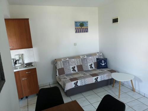 a small room with a bed and a table at Studio Apartment Zen in Murine