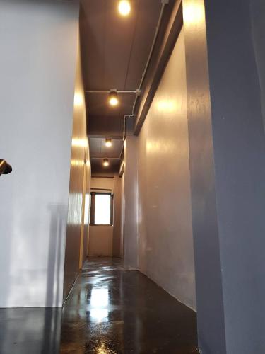 an empty hallway with a window in a building at SleepCatsHostel in Bangkok