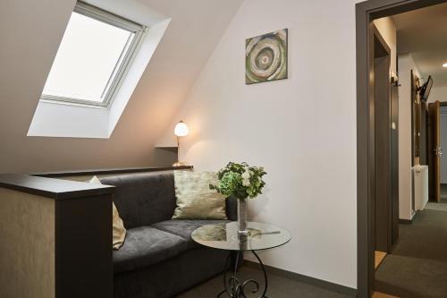 a living room with a couch and a table at Gold House Pension in Balatonfüred