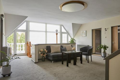 a living room with a couch and a table at Gold House Pension in Balatonfüred