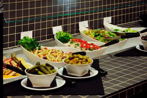 a buffet with several bowls of food on a table at Chateau Nova Yellowhead in Edmonton