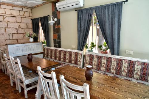 a dining room with a wooden table and chairs at Retro Hostel & Tours in Yerevan