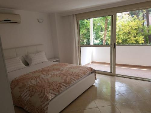 a bedroom with a bed and a large window at Luxury duplex Armand Durres in Golem