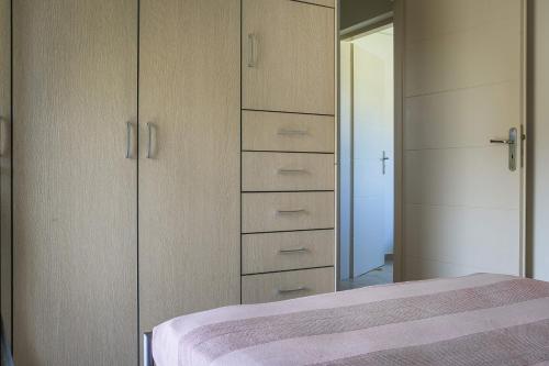 a bedroom with a bed and a mirror at Sea Apartment in Katelios