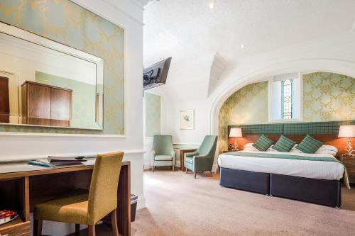 A bed or beds in a room at Craigmonie Hotel Inverness by Compass Hospitality