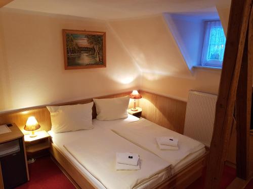 a bedroom with a bed with two boxes on it at Hotel Landgut Ochsenkopf in Rotta