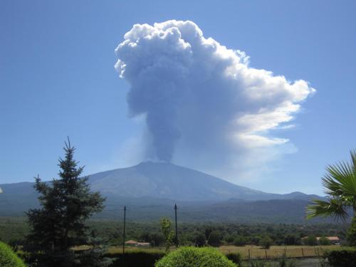 a cloud formation over a mountain in the distance at La Fucina di Vulcano in Bronte