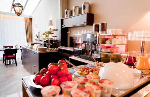 
a kitchen filled with lots of different types of food at Hotel Van Walsum in Rotterdam

