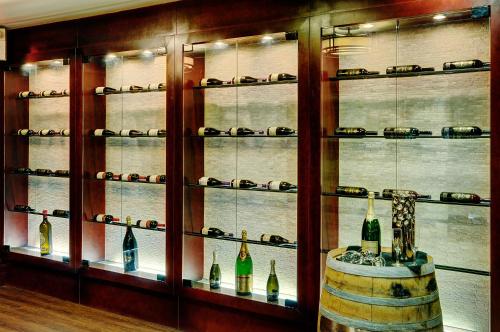 a display case with wine bottles and a barrel at Chateau Nova Yellowhead in Edmonton