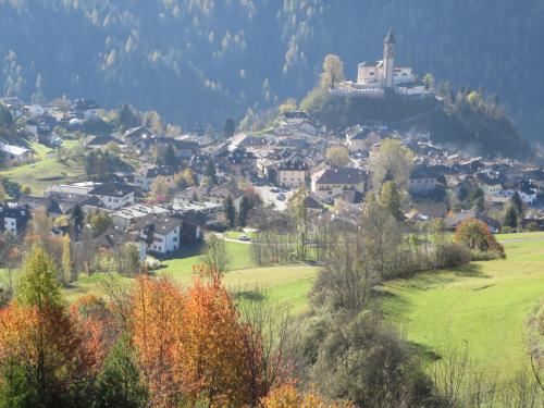 a small town on a hill with a church on top at LA CESURA in Carano