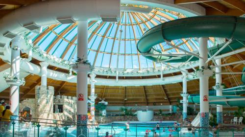 an indoor water park with a large domed ceiling at Aye Stay in Inverness
