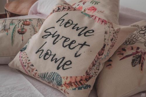 a pillow with the words home sweet home written on it at Mulberry House in Trani