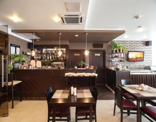 a dining room with tables and a bar at Business Hotel Diplomat in Nizhny Novgorod