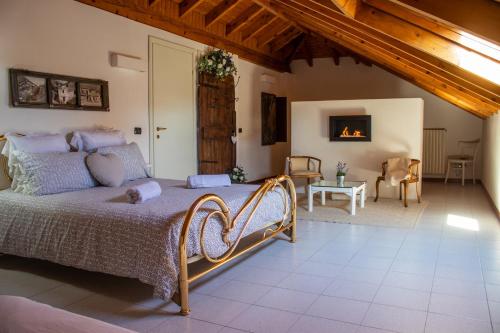 a bedroom with a bed and a living room with a fireplace at Villa le Rondini in Castronno