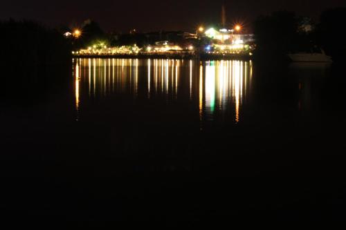 a night view of a city with lights on the water at Hotel Happy Caretta in Dalyan