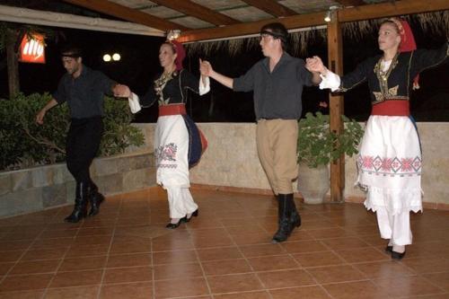 a group of people dancing on a dance floor at Camping Mithimna in Kissamos