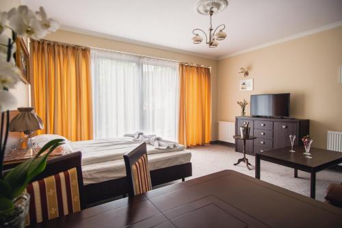 シュクラルスカ・ポレンバにあるWilla 654のベッドルーム(ベッド1台、テーブル、テレビ付)