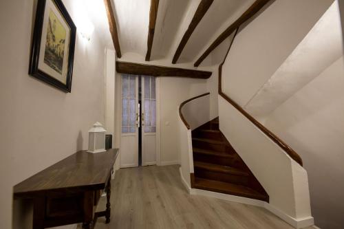 a stairway with a wooden table and a stair case at Casa Rural Pradas in Montanejos