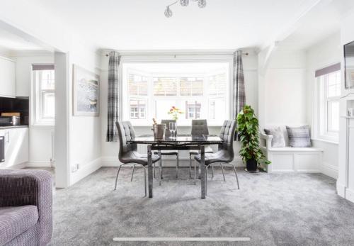 a dining room with a table and chairs at Ammonite Luxury beachfront apartment in Lyme Regis