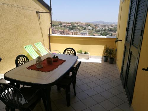 un tavolo e sedie su un balcone con vista di Casa in Centro via gioeni a Agrigento