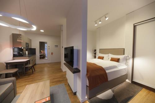 a hotel room with a bed and a living room at HighPark Berlin am Potsdamer Platz in Berlin