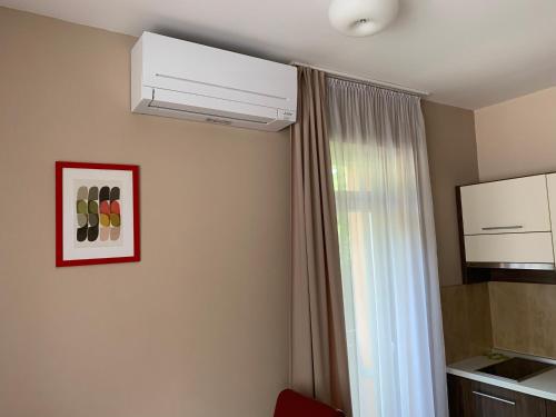 a room with a ceiling fan and a window at Park - apartmány na prenájom in Nové Mesto nad Váhom