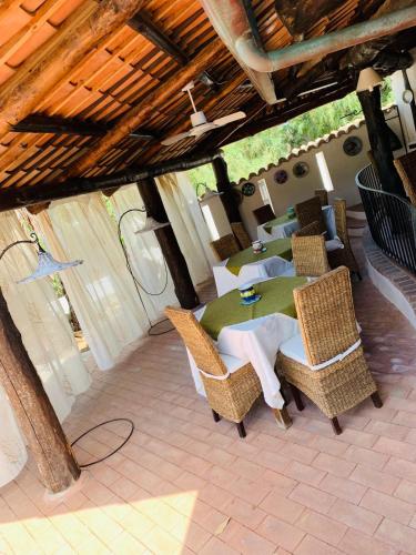 an outdoor dining area with a table and chairs at Residenza Villa Spagnola in Parghelia