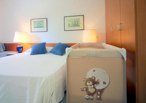 a bedroom with a bed with a teddy bear painted on it at Appartamenti Boboli in Punta Ala