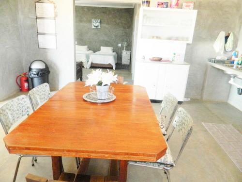 a dining room with a wooden table and chairs at Vastrap Guest Farm in Grünau
