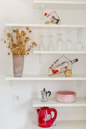 a shelf with a tea kettle and vases on it at Casa Dubi Hvar in Hvar