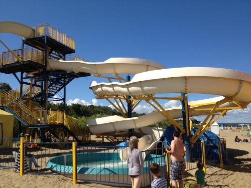 a group of people playing on a slide at a playground at Hostel Gdańsk Sun and Sea in Gdańsk