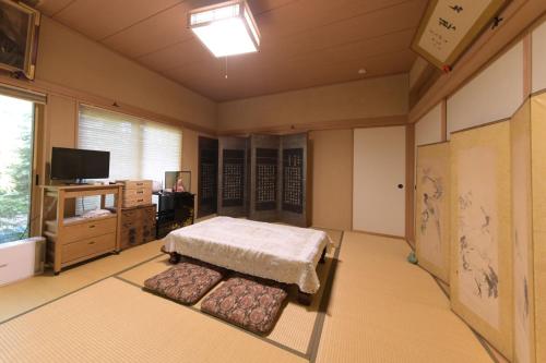 Ένα ή περισσότερα κρεβάτια σε δωμάτιο στο Guesthouse Kizuna