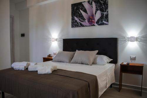 a bedroom with a large bed with two lights on it at Villa Ada in Santa Domenica