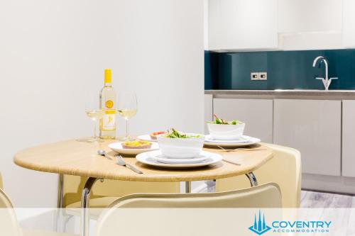 a table with two plates of food on it in a kitchen at Hill Cottage Apartments Coleshill Open for NEC weekend visitors - Hosted By Coventry Accommodation in Coleshill