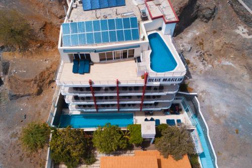 an overhead view of a building with a swimming pool at Blue Marlin Hotel in Mindelo