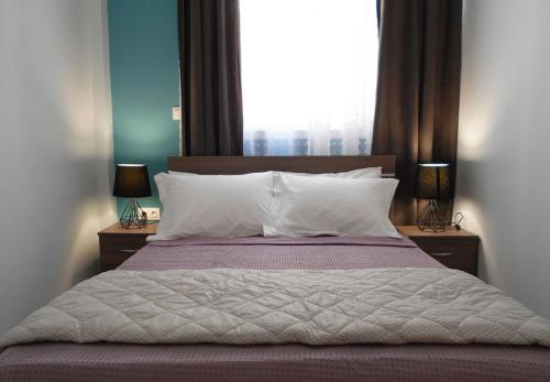 a bedroom with a large bed with a large window at MiCasa SuCasa / Heart of Athens / Brand-New superlux in Athens