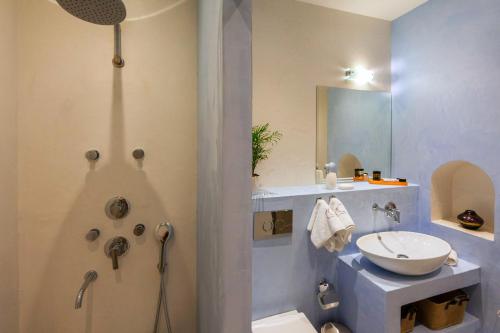 a bathroom with a sink and a shower and a toilet at In Camera Art Boutique Hotel in Rhodes Town