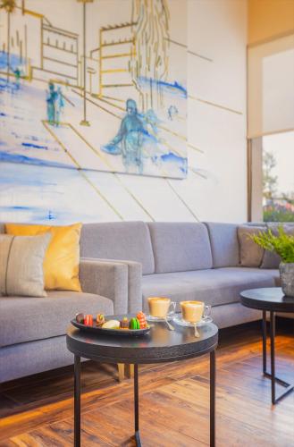 a living room with a couch and a table at Cassia Hotel Jerusalem in Jerusalem