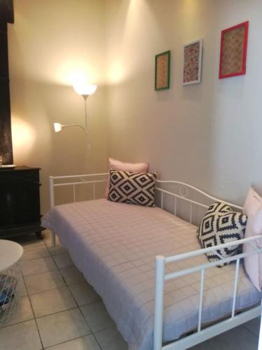 a bedroom with a bed with pillows on it at Sweet Home (50m from center Lithostroto) in Argostoli