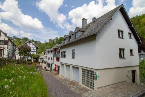 a row of white buildings in a village at Ferienhaus Mühlenberg in Monschau