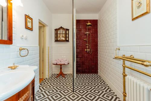 a bathroom with a white sink and a shower at Strieborný dvor in Banská Štiavnica