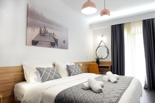 a bedroom with a bed with two pillows on it at Alexandros in Giannitsa
